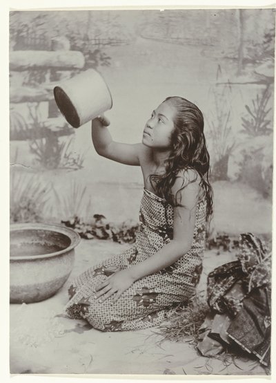 Studio portrait of a young Javanese washing woman by Kassian Cephas