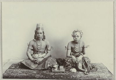 Studio Portrait of a Seated Young Javanese Man and Woman Wearing a Batik Sarong by Kassian Cephas