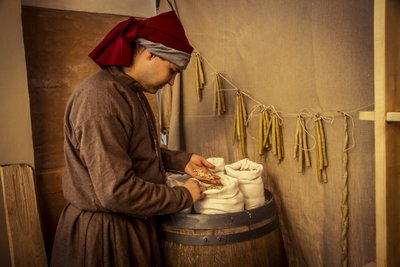 Historical reenactment: Candles and sacks of wheat, rye and barley in the apothecary of Diotaiuti, Imola, Italy, mid-14th century by Unbekannt Unbekannt