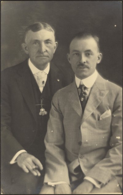 Portrait of Two Men with Suit Accessories by Louis Fleckenstein