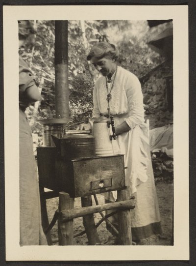 Woman Using Outdoor Stove by Louis Fleckenstein