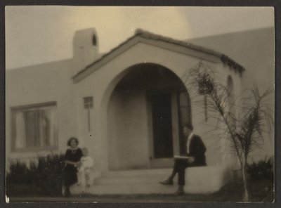 Woman and Man in Front of a House by Louis Fleckenstein