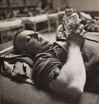 Military convalescent examining a small bottle with a chemical preparation by Luigi Leoni