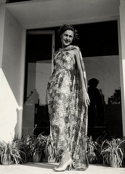 Model wears a long dress with a floral pattern created by the couture house 