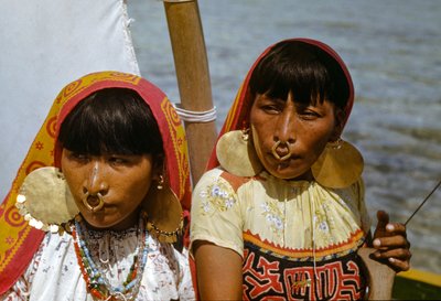 Women with gold nose rings of Cuna tribe of Mulatas aka San Blas Islands paddle and sail by Luis Marden