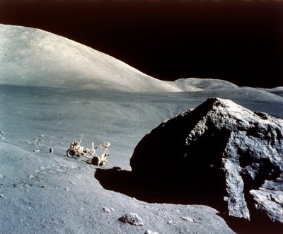 The Rover is dwarfed by a giant rock on the lunar surface, Apollo 17 mission by NASA Images