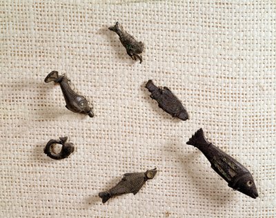 Christian antiquity: fibulae and metal jewelry in the shape of fish. National Museum of Archeology, Saint Germain en Laye by Paleo Christian Paleo Christian