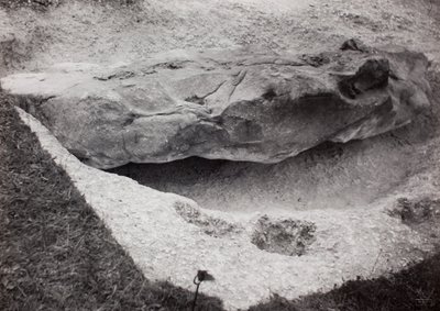 Rock recessed in grass by Paul Nash