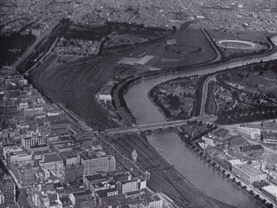 Melbourne: An aerial view of the Jolimont Railway Yards and the River Yarra, Showing a small section of the city and Richmond in the distance by Photographer Australian