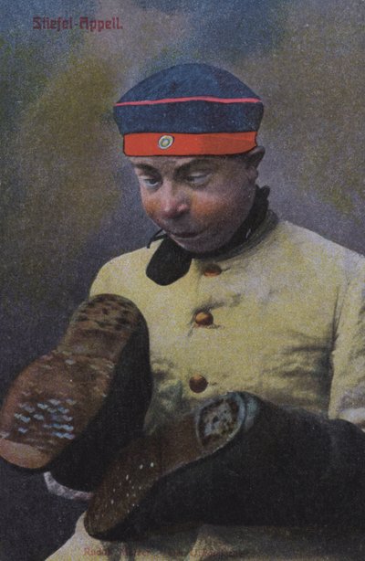 German soldier looking at the soles of his boots by Photographer German