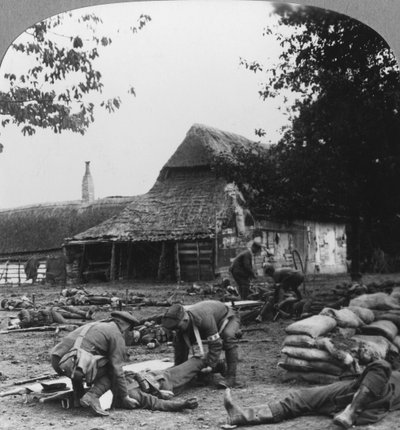 Stretcher bearers caring for wounded at an improvised first aid post, World War I, c1914-c1918 by Realistic Travels Publishers