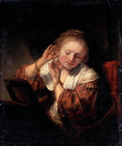 Young Woman Trying on Earrings by Rembrandt van Rijn