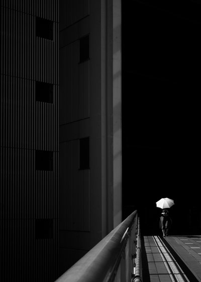 Solitary Umbrella Walker by Satoshi Hata