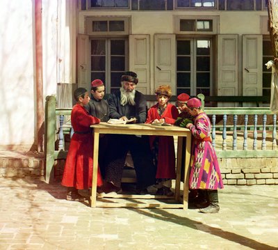 A Group of Jewish Children with a Teacher on a Table in Front of a House, Samarkand by Sergey Prokudin Gorsky