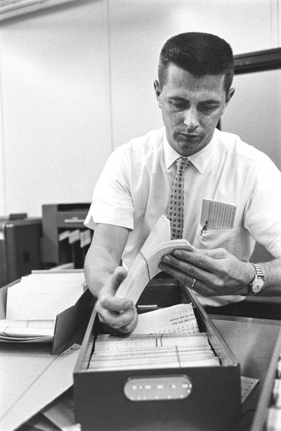 Computer operator Don Murray working with IBM early digital computer that use punch cards by Ted Spiegel