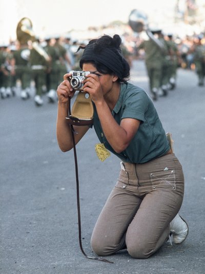 Israeli woman takes photograph of Passover military parade in Jerusalem by Ted Spiegel