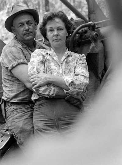 Man and woman, husband and wife, embrace and relax at end of work day by Ted Spiegel