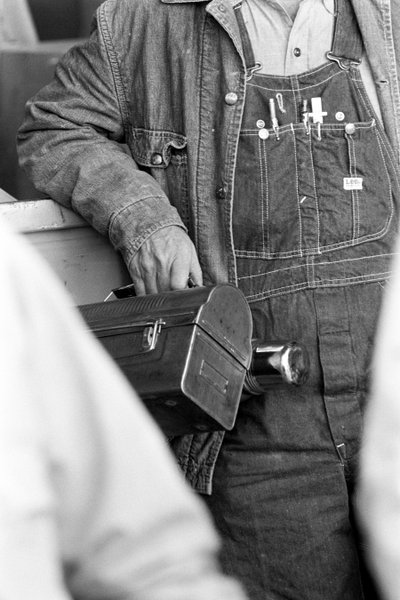 Worker in Dungarees Holding a Lunchbox (Electrolytic Copper Processing at Phelps Dodge) by Ted Spiegel