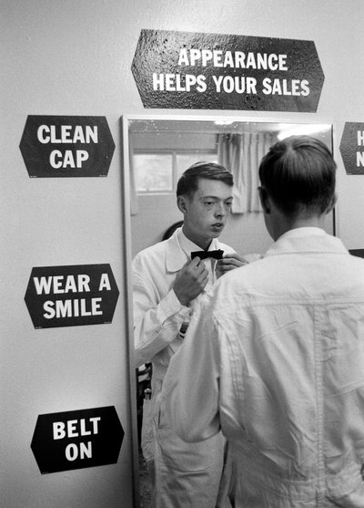 Young man training to be gas station attendant at Chevron station by Ted Spiegel