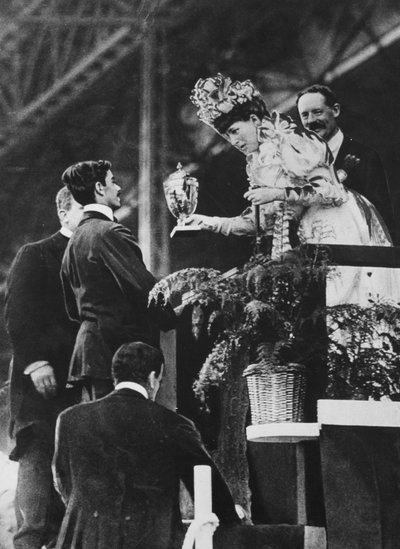 Queen Alexandra handing a special cup to Dorando to commemorate his great effort to win the Olympic marathon in July, 1908 by Thomas E. and Horace Grant Grant