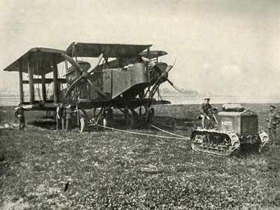 A Small Motor Tractor Getting a Huge R.A.F. Bombing Machine into Position by Unbekannt