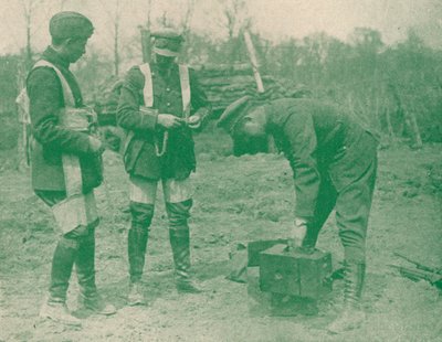 Aerial photographers fixing on parachute harnesses before making an ascent, c1917 by Unbekannt