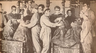Munition Workers Wearing Respirators While Filling Shells with Trinitrotoluene (T.N.T.) by Unbekannt