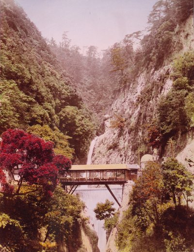 Covered bridge in a steep gorge, with waterfalls in the background, Japan, c.1890-1910 by Unbekannt