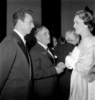 The Movie Critic Georges Sadoul with the Actor and Pop Singer Yves Montand and the Begum Jeanne Andre of Aix les Bains in Cannes - 1954 by Unbekannt