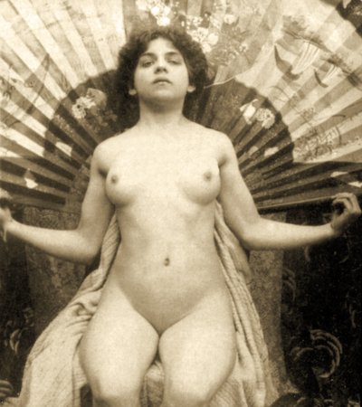 Female Nude Posing with a Large Fan by Unknown