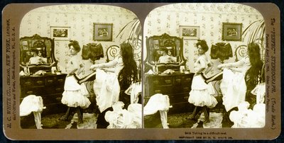 Stereoscopic card depicting a woman being laced into a corset, c.1900 by Vermont, USA H.C. White Company
