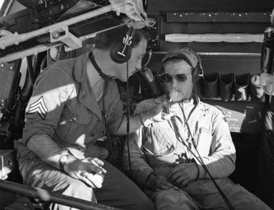 Army Air Corps crew in a B-17 share cigarettes during training at MacDill Field in WWII by Volkmar Wentzel