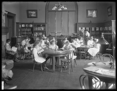 Children reading in the reading room of an unidentified branch of the Queens Borough Public Library, c.1910 by William Davis Hassler