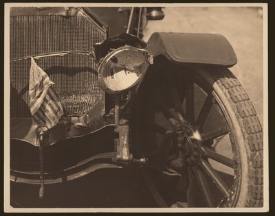 Close-up of Damaged Headlight and Grill on Automobile by William G. Swekosky