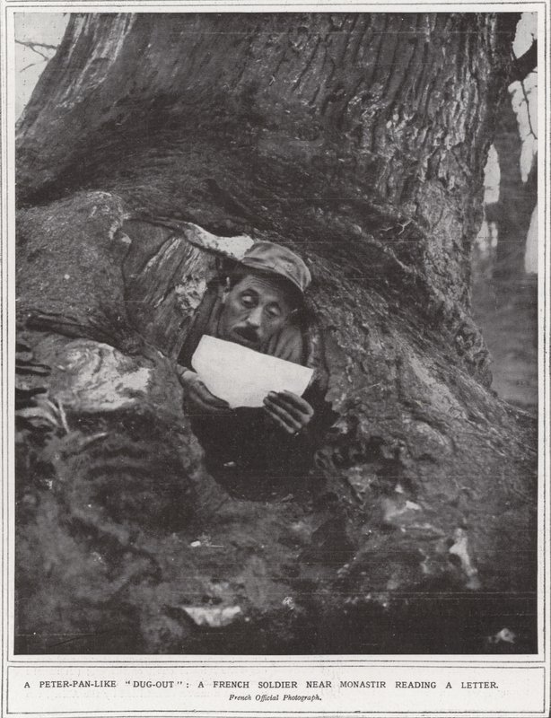 A Peter-Pan-like "dug-out", a French soldier near Monastir reading a letter by (after) English photographer