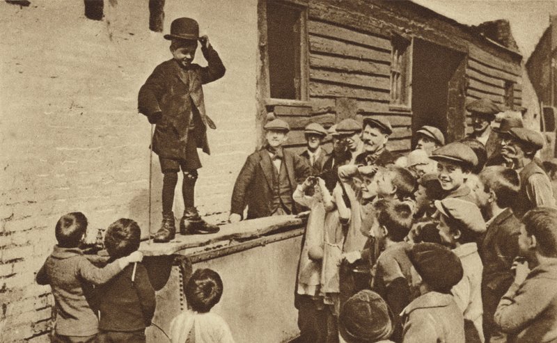 A Budding Humorist of the East End Doing a Charlie Chaplin Impression by English Photographer