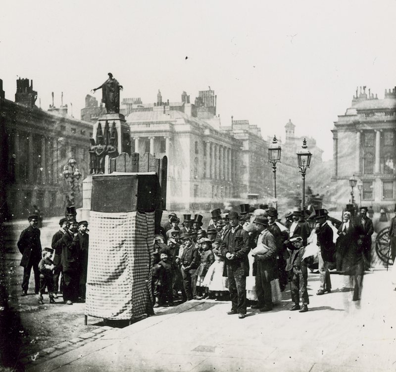 A Crowd Gather to Watch a Puppet Show in London by English Photographer