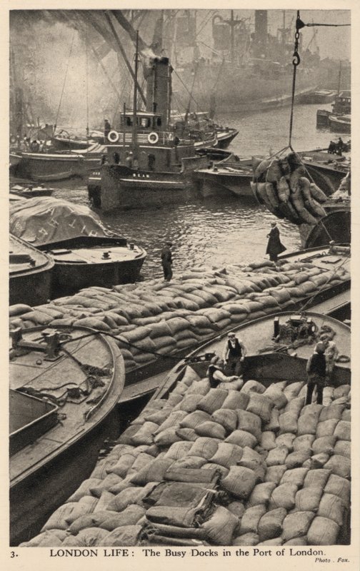 Boats and barges in the busy docks of the port of London by English Photographer