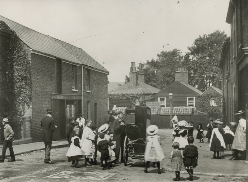 Crowd of Children Gather Around a Street Organ by English Photographer