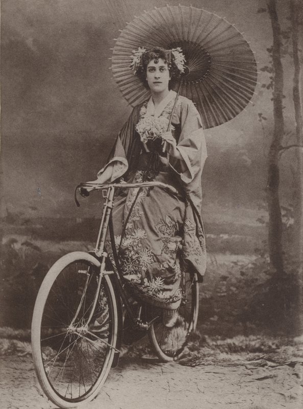 Girl on bicycle, dressed in the Japanese fashion by English Photographer