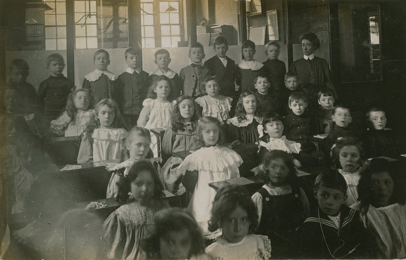 Pupils Sitting Behind Their Desks as They Pose for a Portrait by English Photographer