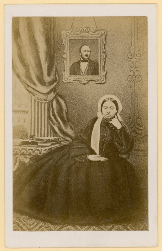 Queen Victoria, when a widow, with a portrait of the Prince Consort behind her by English Photographer