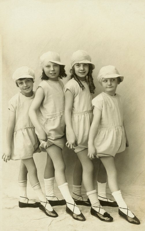 Row of four girls pointing their toes by English Photographer