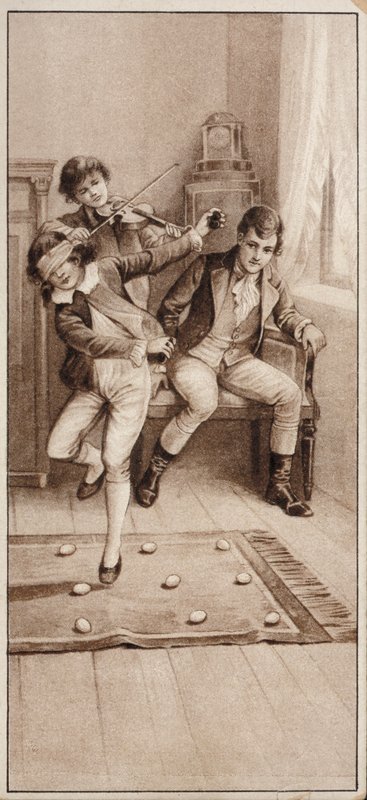 Boy playing a game where he has to try to avoid stepping on eggs while blindfolded by English School