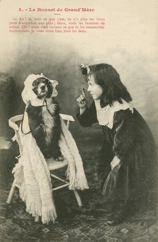 Child Dressing Her Dog in a Bonnet by French Photographer
