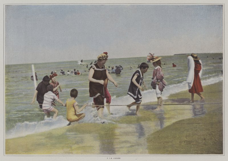 Children playing with a rope at the beach by French Photographer