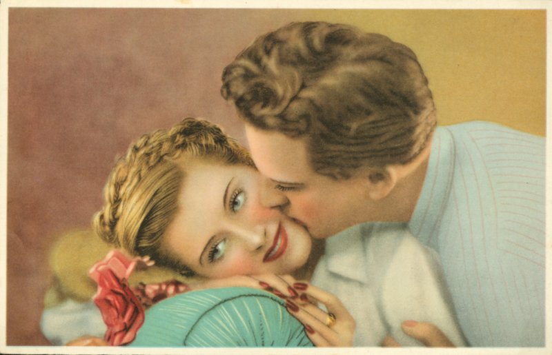 Young Man Kissing a Pretty Girl on the Cheek by French Photographer