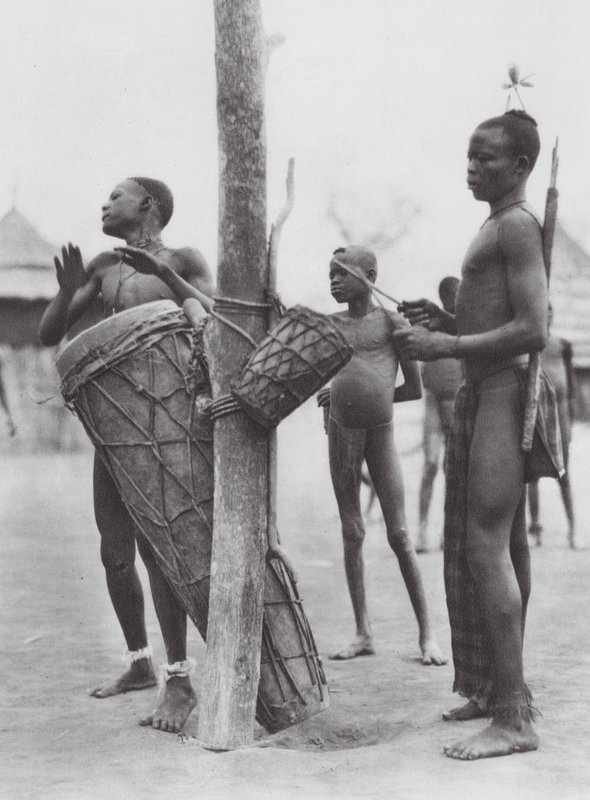 Africa: Moru men playing drums by Hugo Adolf Bernatzik