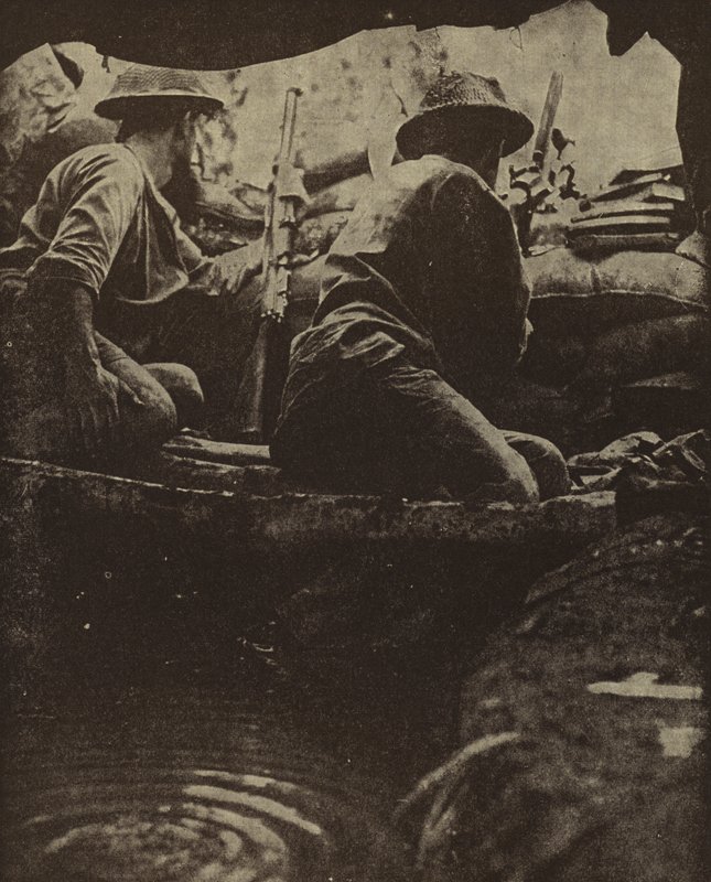 Australian soldiers in a water-filled rifle pit, Sanananda, New Guinea, World War II by Photographer Australian