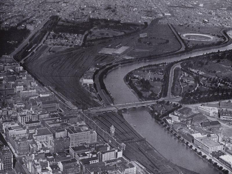 Melbourne: An aerial view of the Jolimont Railway Yards and the River Yarra, Showing a small section of the city and Richmond in the distance by Photographer Australian